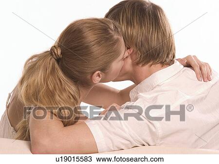 Stock Image - Rear view of a young couple hugging. Fotosearch