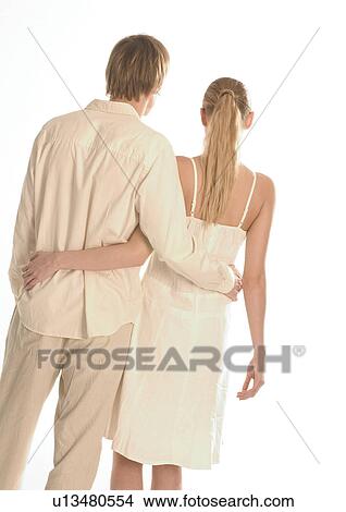 Rear view of a young couple View Large Photo Image Picture - Rear view of a young couple. Fotosearch