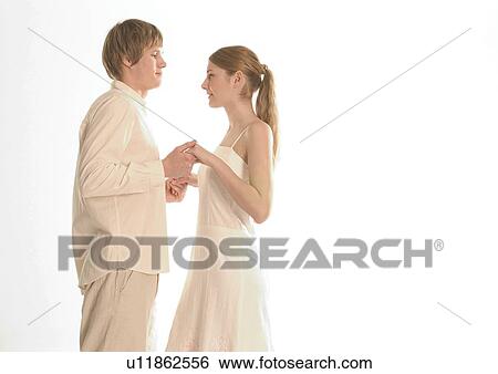 Side profile of a young couple dancing View Large Photo Image Stock Photograph - Side profile of a young couple dancing. Fotosearch