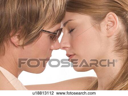 Side profile of a young couple hugging View Large Photo Image Stock Image - Side profile of a young couple hugging. Fotosearch