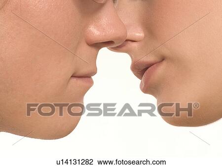 Side profile of a young couple kissing View Large Photo Image Stock Image - Side profile of a young couple kissing. Fotosearch
