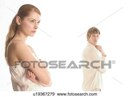 Side profile of a young couple standing apart View Large Photo Image Stock Photo - Side profile of a young couple standing apart. Fotosearch
