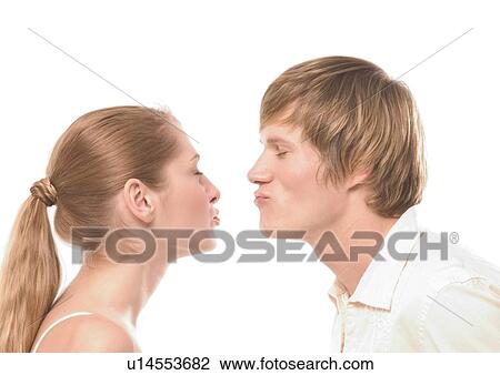 Side profile of a young couple puckering at each other View Large Photo Image Stock Image - Side profile of a young couple puckering at each other. Fotosearch