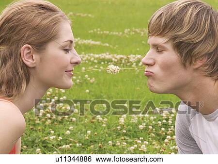 Side profile of a young couple puckering at each other View Large Photo Image Stock Photograph - Side profile of a young couple puckering at each other. Fotosearch