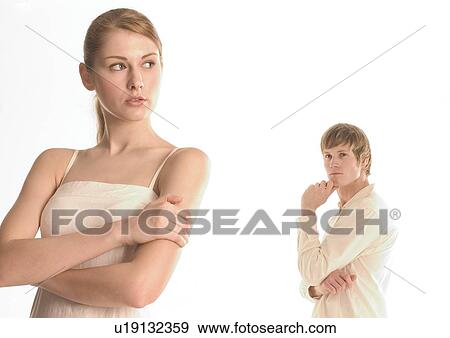 Stock Photo - Young man standing behind a young woman. Fotosearch