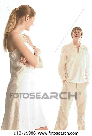Stock Photograph - Young woman looking at a young man. Fotosearch