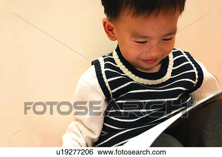 Stock Photograph - Casual Clothing, Innocence, Sitting, Holding, Close-Up, 3-4 Years. Fotosearch