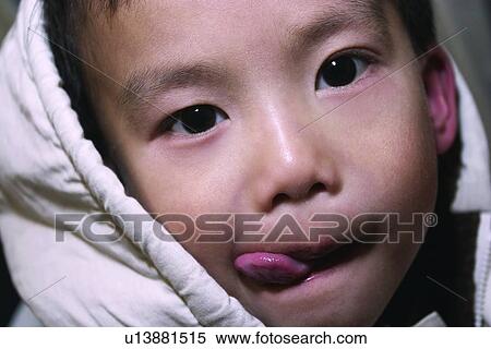 Casual Clothing, Looking At Camera, Indoor, Innocence, Sticking Out Tongue, One Boy Only View Large Photo Image Stock Photography - Casual Clothing, Looking At Camera, Indoor, Innocence, Sticking Out Tongue, One Boy Only. Fotosearch