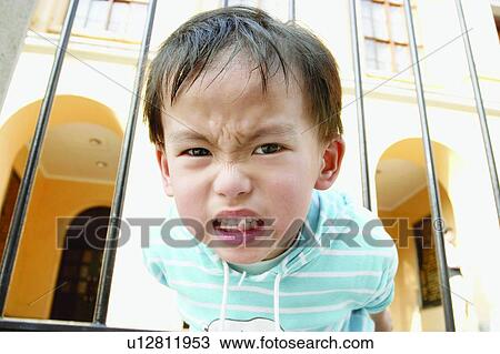 Stock Image - Clenching Teeth, Close-Up, 4-5 Years, Asian, Pulling, One Person, Outdoor. Fotosearch