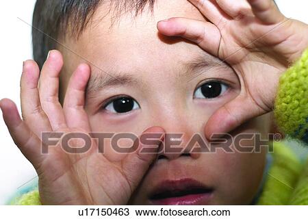 Stock Image - Close-Up, Kids Life, Head And Shoulders, Human Finger, Human Face, Looking At Camera. Fotosearch