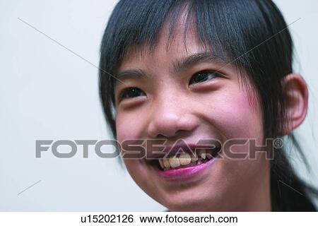 Stock Photograph - Eastern, Looking Away, Indoor, One Child Only, Smiling, Human Face, 6-7 Years. Fotosearch