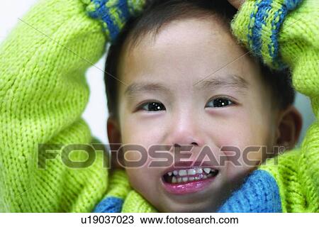 Stock Image - Innocence, Head And Shoulders, One Child Only, One Boy Only, Close-Up, Looking At Camera, Asian. Fotosearch