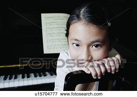 Stock Photo - One Child Only, Head And Shoulders, Innocence, Musical Instrument, Hair Clip, Contemplation. Fotosearch