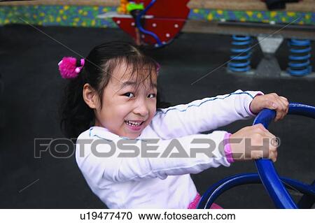 Stock Image - Playful, Smiling, Casual Clothing, One Girl Only, Child, Looking At Camera. Fotosearch