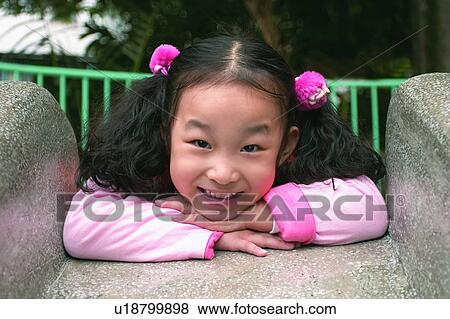 Toothy Smile, Asian, Leaning, One Child Only, Innocence, Pigtails View Large Photo Image Stock Photo - Toothy Smile, Asian, Leaning, One Child Only, Innocence, Pigtails. Fotosearch