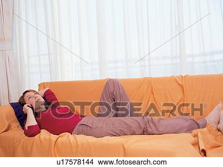 Picture - barefoot, brown hair, casual clothing. Fotosearch