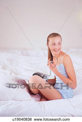 Stock Photo - bed, bedding, bedroom, brown hair. Fotosearch