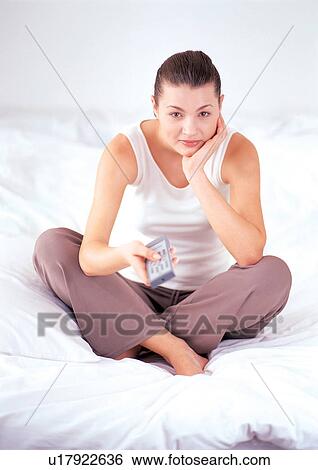 Stock Photograph - bed, bedding, bedroom, brown hair. Fotosearch