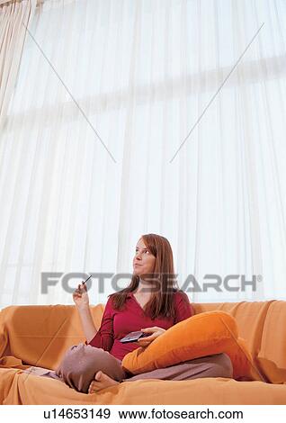 brown hair, couch, cross legged View Large Photo Image Stock Photo - brown hair, couch, cross legged. Fotosearch