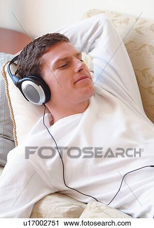 Stock Image - gadget, content, leisure, fun, pleasure, head and shoulder, earphones. Fotosearch