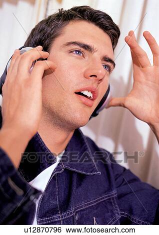 Stock Photograph - joy, resting, gesturing, youthful, brown hair, casual clothing. Fotosearch
