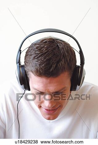 Man listening to headphones View Large Photo Image Stock Photo - Man listening to headphones. Fotosearch