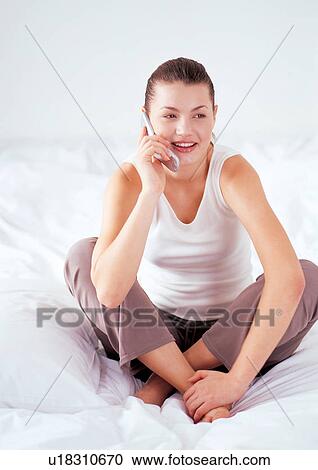 Stock Image - one person, new generation, bedding, bed sheet, talking, duvet. Fotosearch