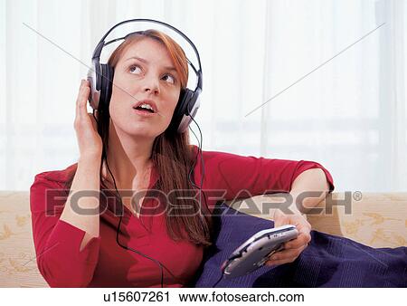 Stock Image - personal compact disc player, young woman, leisure, earphones, gadget, head and shoulder. Fotosearch
