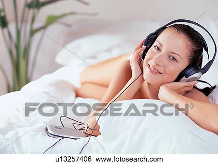 smiling, hobby, bed, phones, leisure new generation View Large Photo Image Stock Photograph - smiling, hobby, bed, phones, leisure new generation. Fotosearch