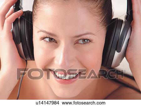 Woman listening to headphones View Large Photo Image Picture - Woman listening to headphones . Fotosearch