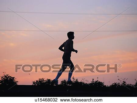 Stock Image - exercise, sky, shadow, leisure, jogging, cloud, jogger. Fotosearch