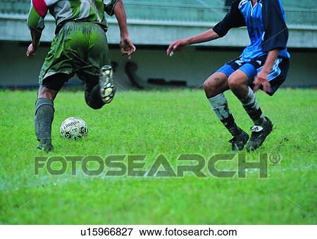 Stock Photo - exercise, soccer ball, football field, recreation, leisure, game. Fotosearch