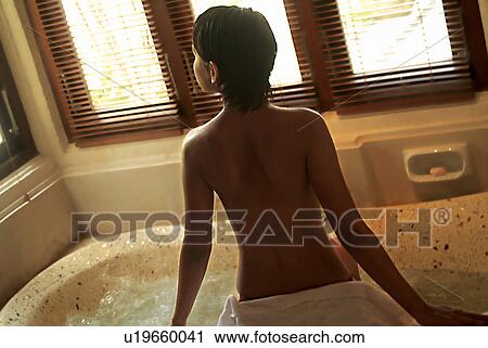 Stock Image - Bathtub, Blinds, Black Hair, Asian Ethnicity. Fotosearch