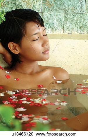 Stock Image - Leaning, Vacations, Beauty, Indoor, Asian Ethnicity, Short Hair. Fotosearch