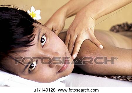 Stock Photo - Wearing Flower, Massaging, Well Being, Close-Up, Two People, Portrait. Fotosearch