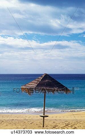 Stock Image - Sand, Sea, Horizon, Umbrella, Cloud, Water. Fotosearch