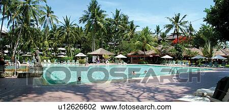 Stock Image - Shadow, Relaxation, Vacations, Sunbathing, Leisure Activity, Deck Chair, Umbrella. Fotosearch
