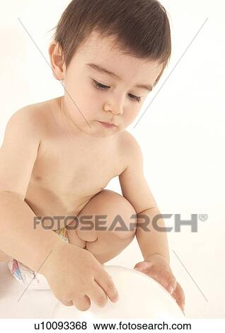 Close-up of a boy holding a ball View Large Photo Image Stock Photo - Close-up of a boy holding a ball. Fotosearch