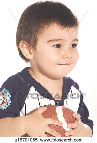 Stock Photography - Close-up of a boy holding a football. Fotosearch