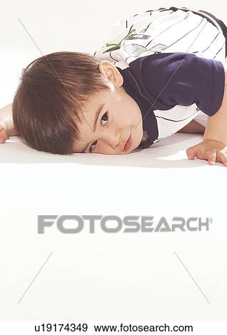 Close-up of a boy putting his face to the floor View Large Photo Image Stock Photo - Close-up of a boy putting his face to the floor. Fotosearch