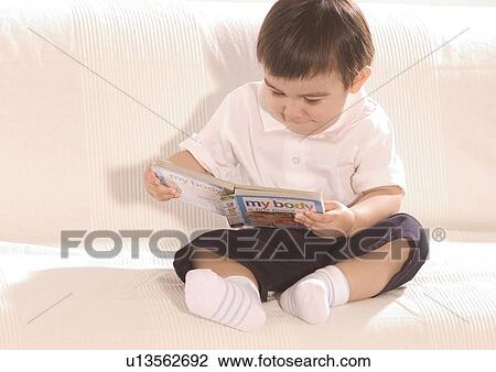 Close-up of a boy reading a book View Large Photo Image Stock Image - Close-up of a boy reading a book. Fotosearch