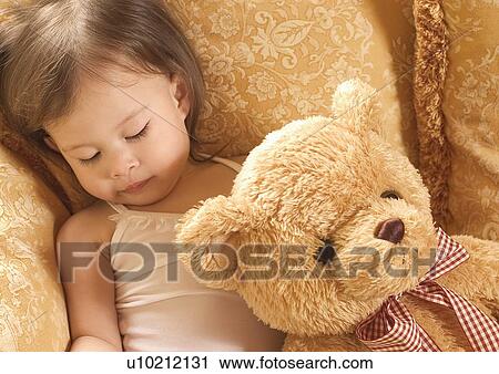 Close-up of a girl holding a teddy bear View Large Photo Image Stock Image - Close-up of a girl holding a teddy bear. Fotosearch