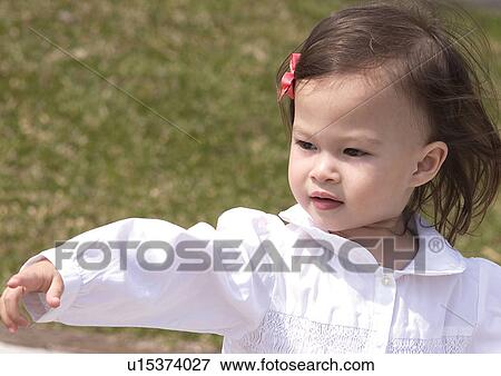 Stock Photo - Close-up of a girl pointing. Fotosearch