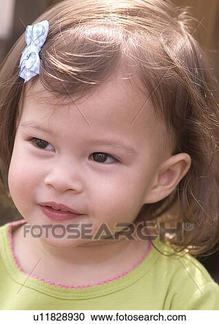 Stock Image - Close-up of a girl smiling. Fotosearch