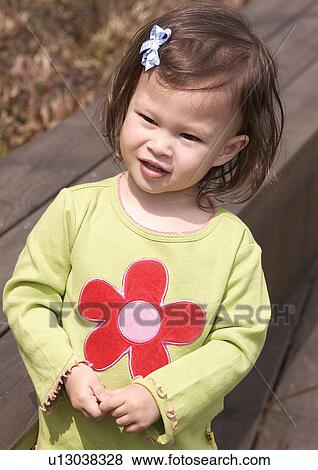 Close-up of a girl smiling View Large Photo Image Stock Photo - Close-up of a girl smiling. Fotosearch