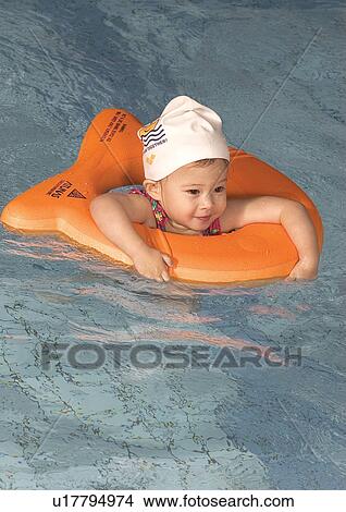 Picture - High angle view of a girl in a swimming pool. Fotosearch