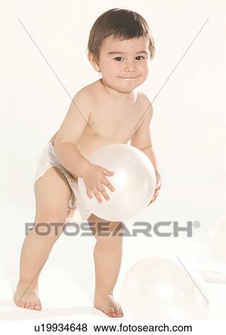 Portrait of a boy holding a ball View Large Photo Image Stock Photo - Portrait of a boy holding a ball. Fotosearch