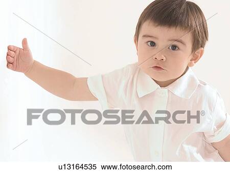Portrait of a boy touching the wall View Large Photo Image Stock Photography - Portrait of a boy touching the wall. Fotosearch
