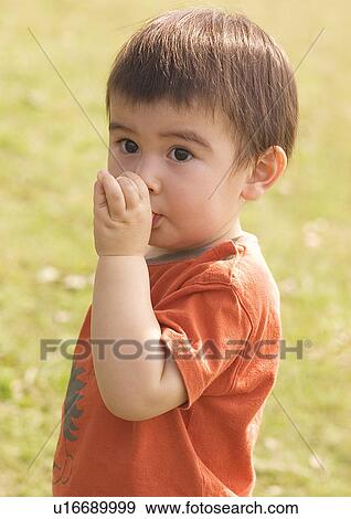Stock Photo - Side profile of a boy sucking his thumb. Fotosearch