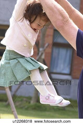 Side profile of a girl being lifted by a person View Large Photo Image Stock Photo - Side profile of a girl being lifted by a person. Fotosearch